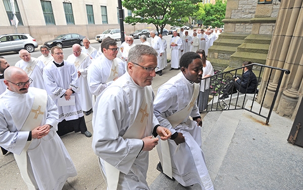 Four deacons, soon to be priests, prepare to be ordained (front to back, clockwise) Father Gerard Skrzynski, Father Peter Santandreu, Father Paul Stanislaw Cygan, Father Peter Nsa Bassey make their way into St. Joseph Cathedral as they prepare to be ordained. (Dan Cappellazzo/Staff Photographer)